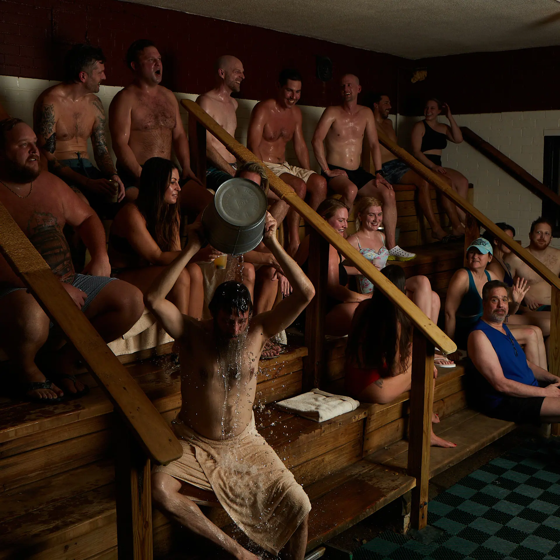 People sitting in a steam room together.