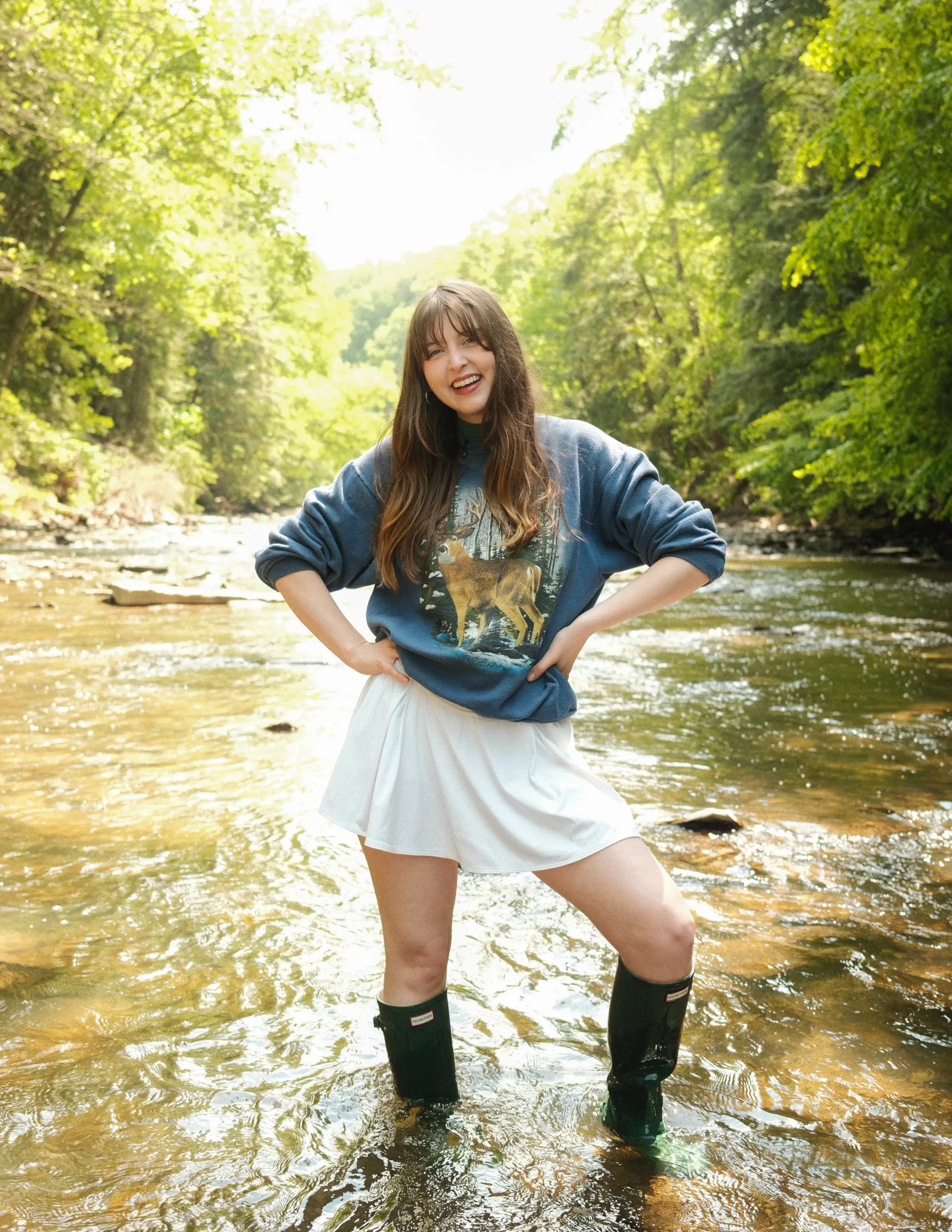 Anna Henry posing in a creek