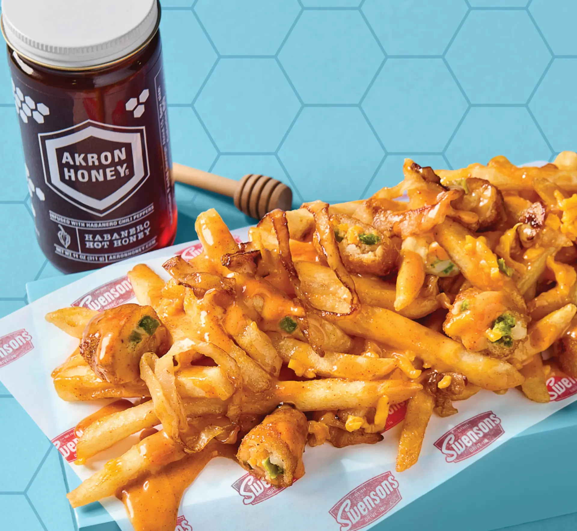 loaded fries with cheese, potato teezers and hot honey sauce