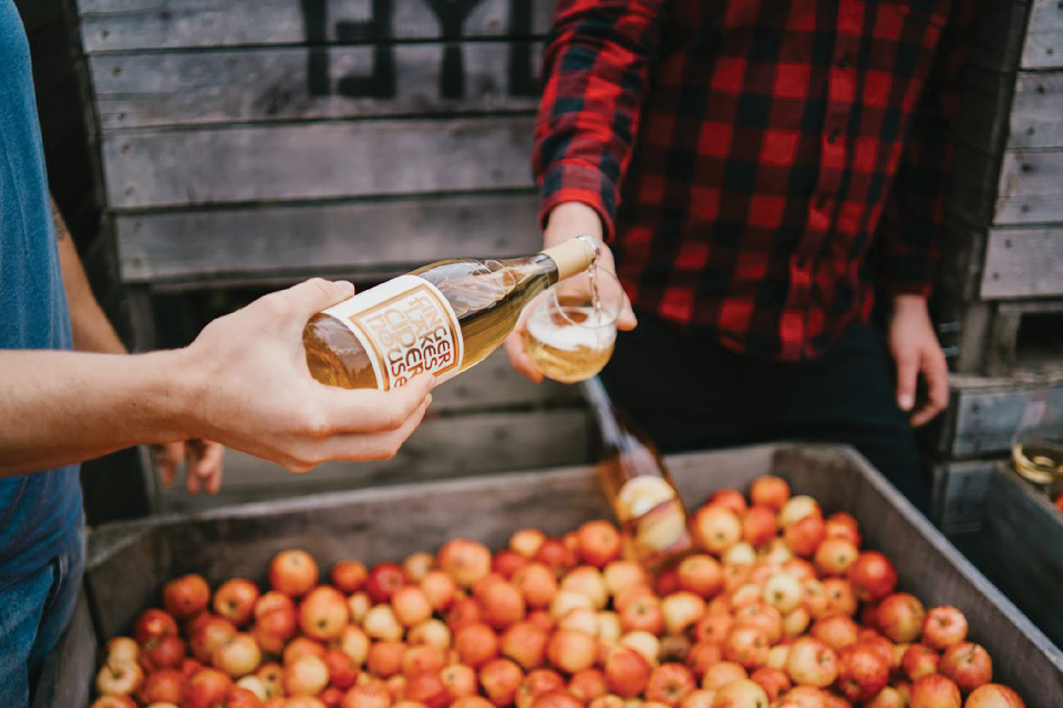 Person pouring cider into glass at Finger Lakes Cider House in Interlaken, New York (photo by Hannah Stokes) Person pouring cider into glass at Finger Lakes Cider House in Interlaken, New York (photo by Hannah Stokes)