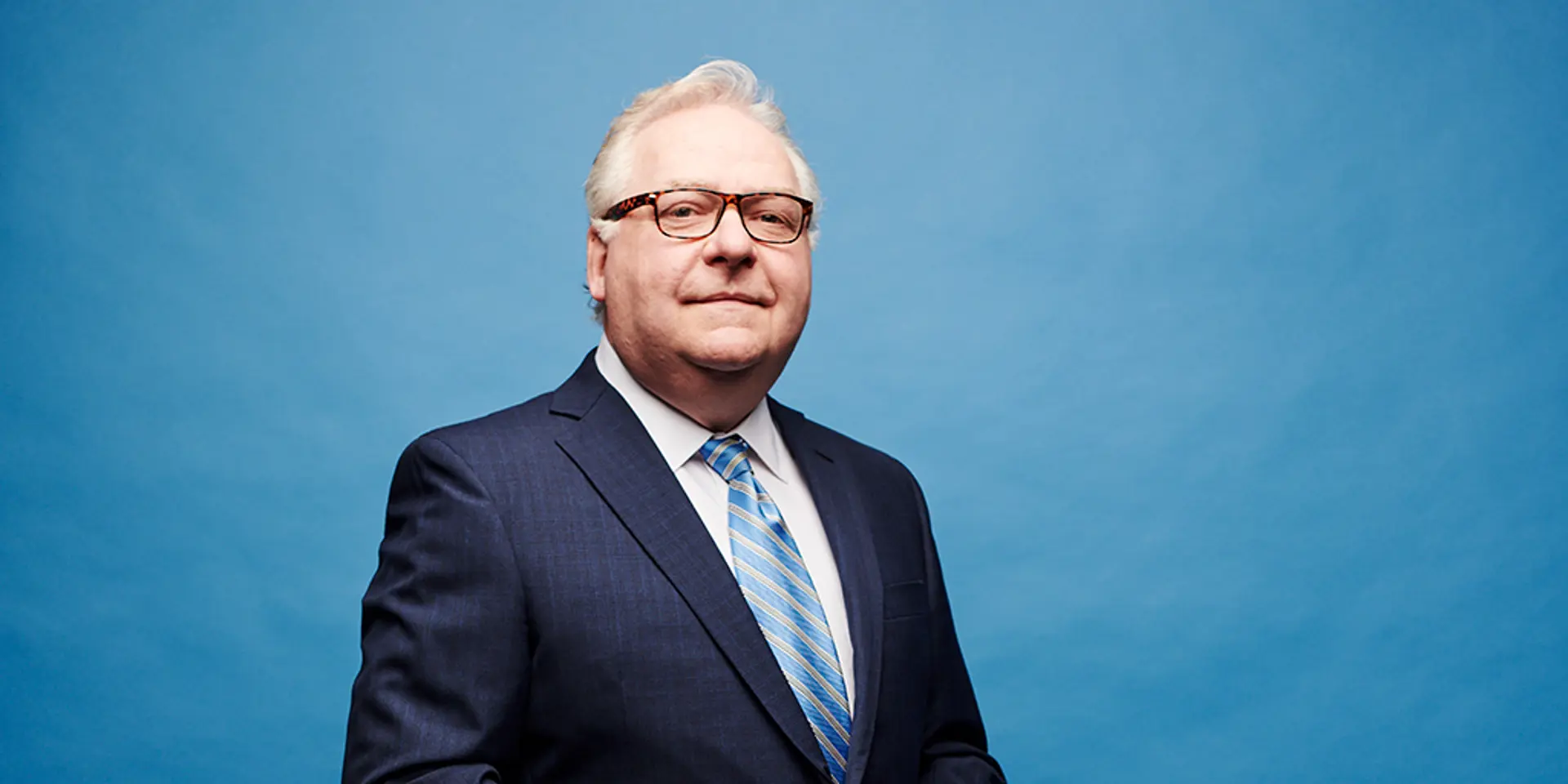 Portrait of a man in a blue suit.