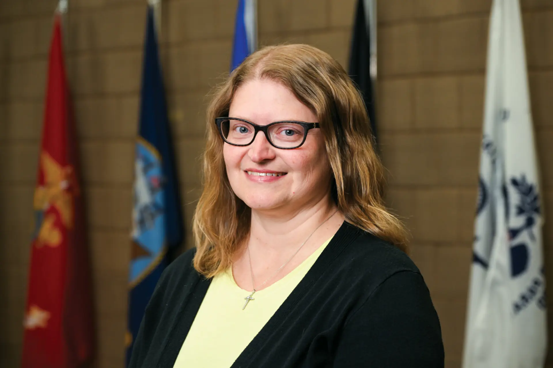 a woman in glasses smiling
