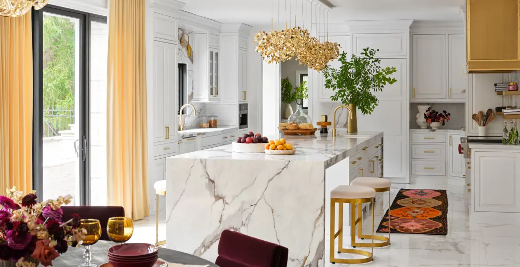 White kitchen with gold accents and marble countertop
