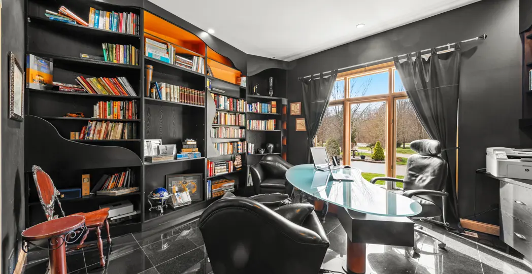 black office with staggered bookshelves