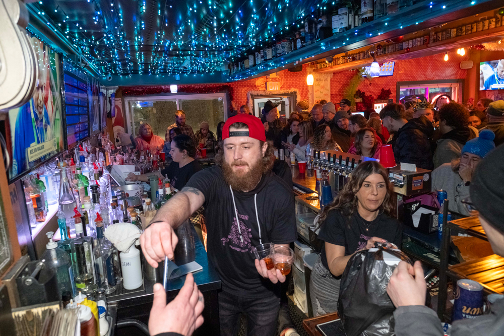 A bartender works at Sloppy Bob's in Parma at midnight on New Year’s Eve