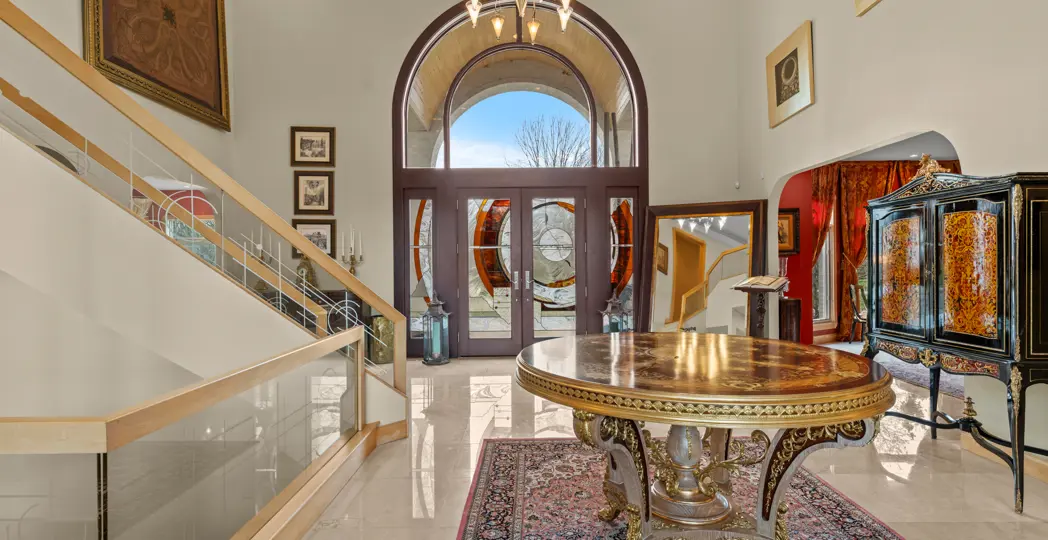foyer with white marble floors and ornate decor