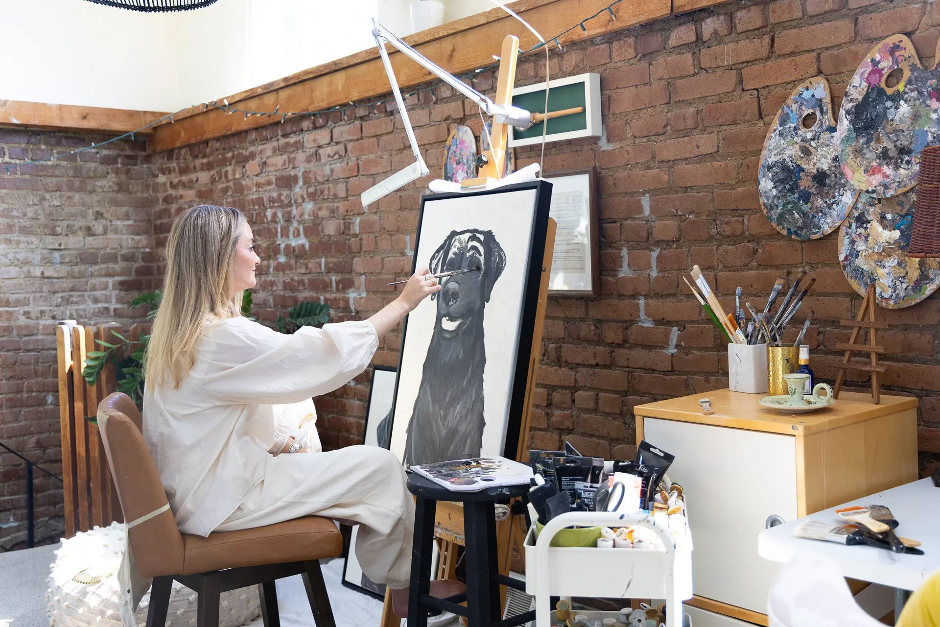 artist painting a portrait of a dog