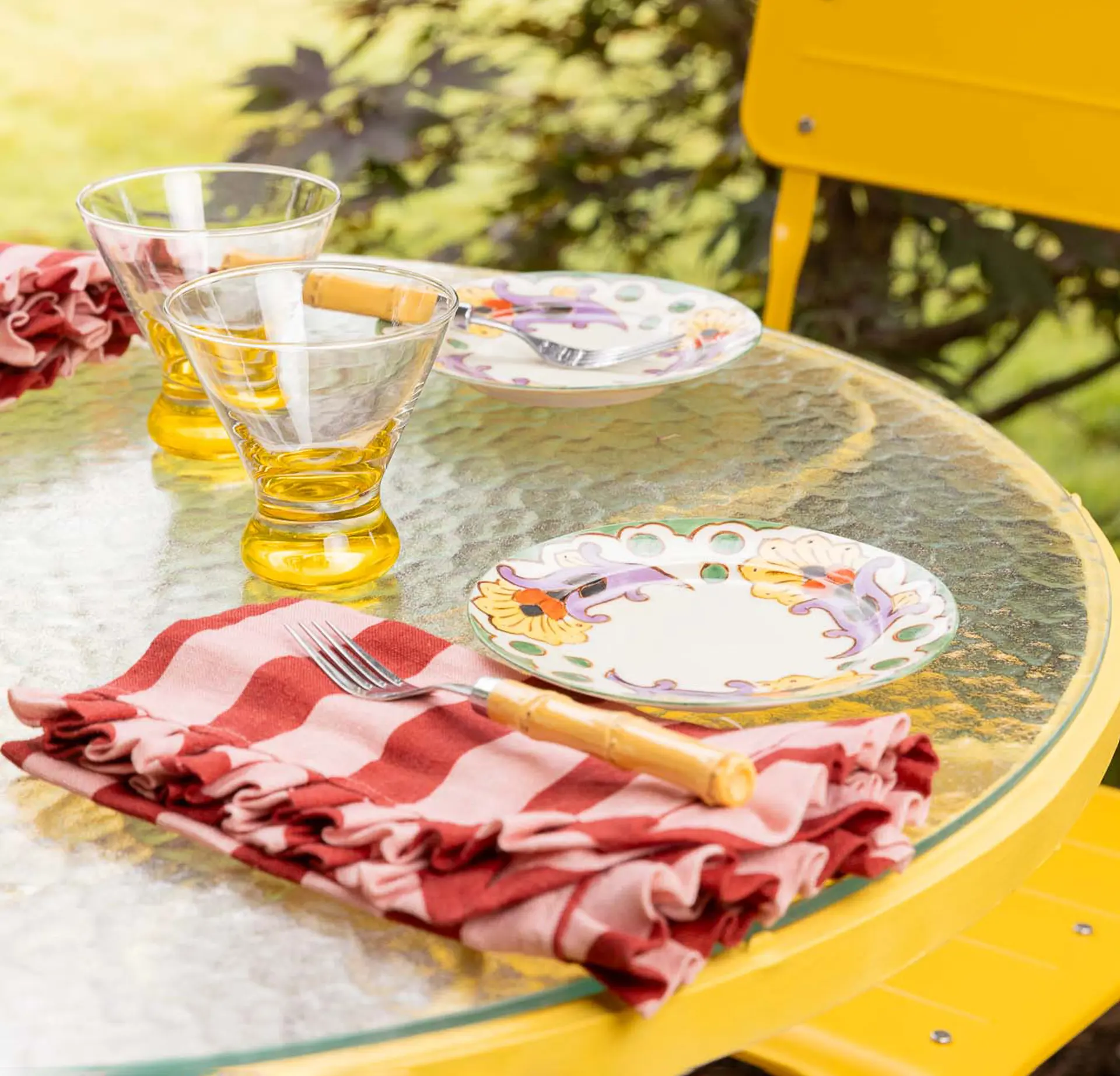 porch table with dainty plate and red and pink napkins