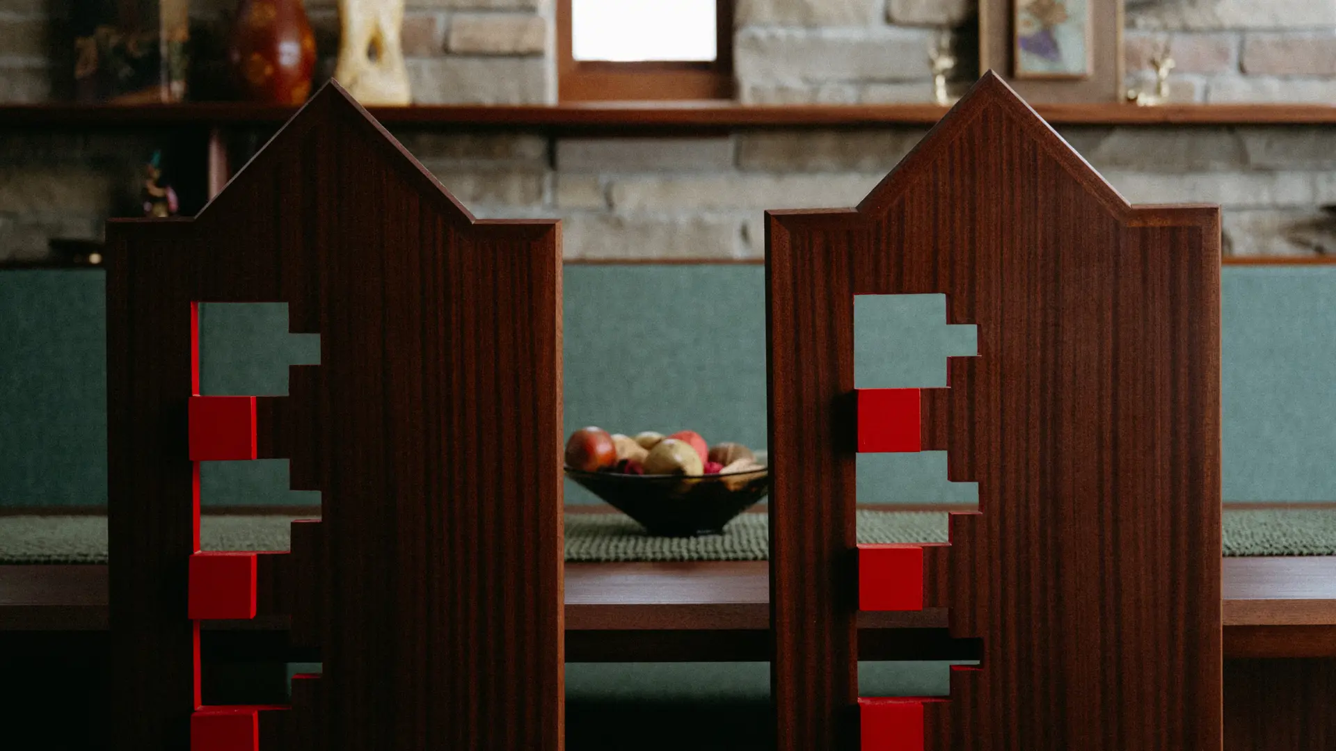 Signature red details accentuate tints in the wooden chairs. | Photographed by Suzuran Photography