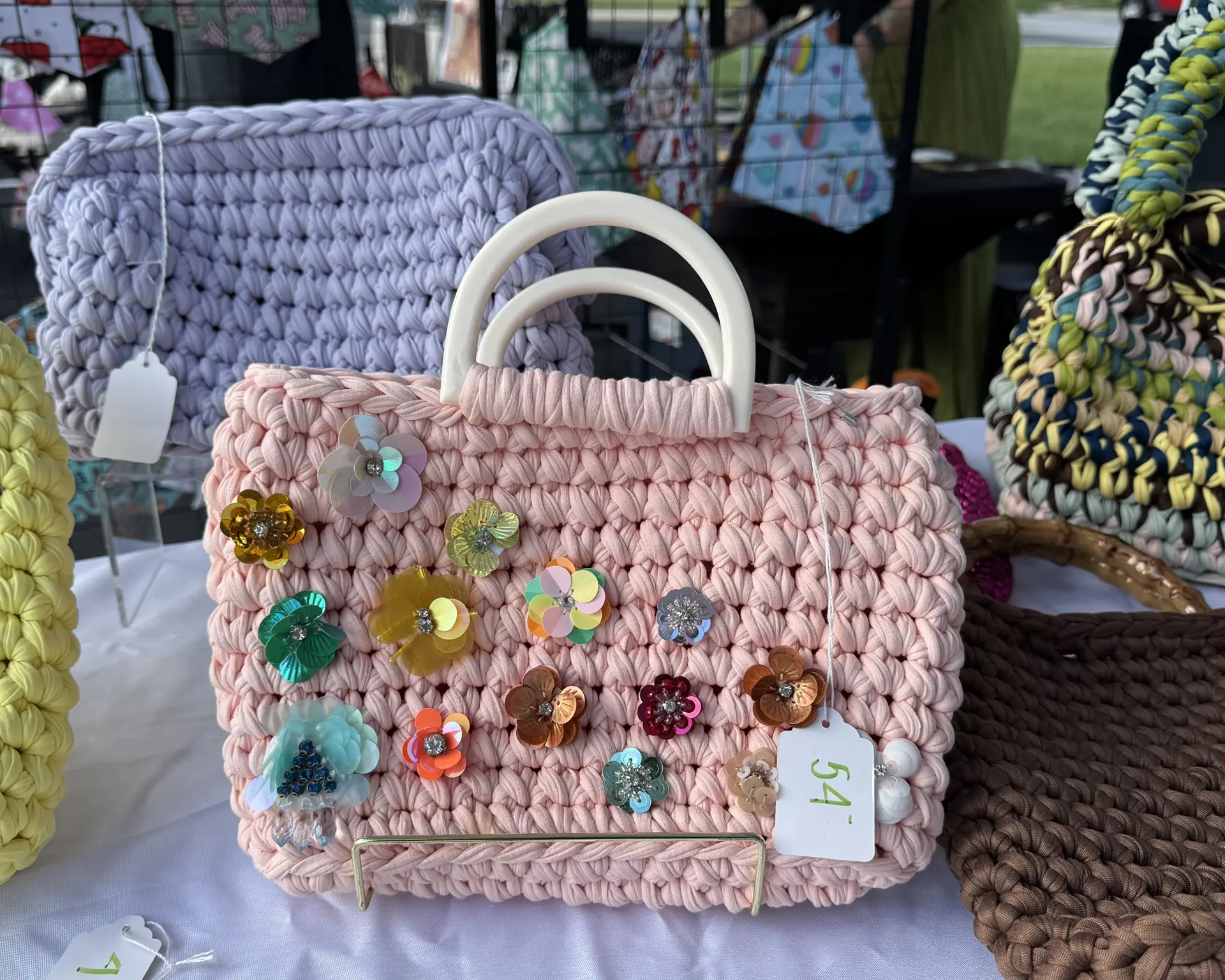 pink crocheted handbag with flower decals
