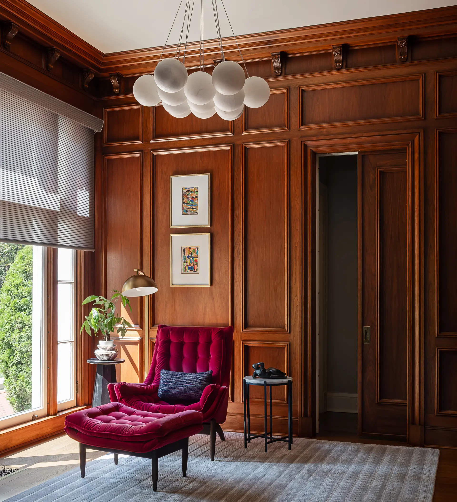 wood wall behind a red chair