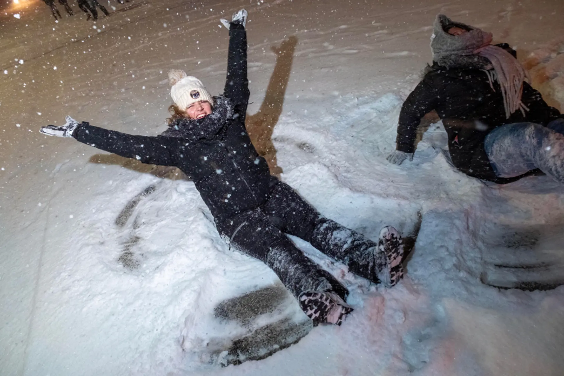 Snow angels and festive glasses outside Sloppy Bob’s in Parma at midnight on New Year’s Eve.