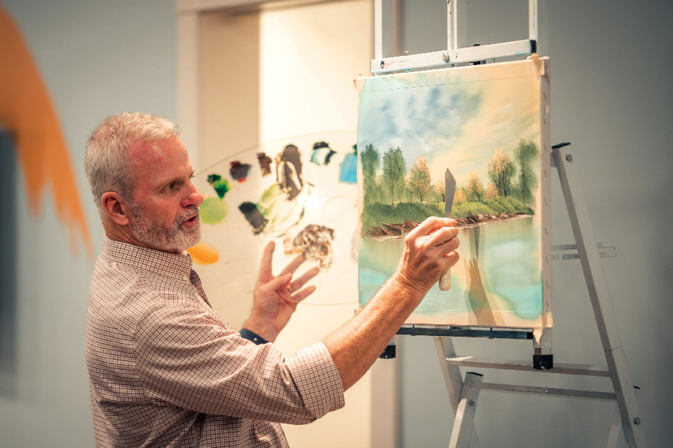 Man painting at Minnetrista Museum & Gardens’ Bob Ross Experience in Muncie, Indiana (photo courtesy of the Bob Ross Experience) Man painting at Minnetrista Museum & Gardens’ Bob Ross Experience in Muncie, Indiana (photo courtesy of the Bob Ross Experience)