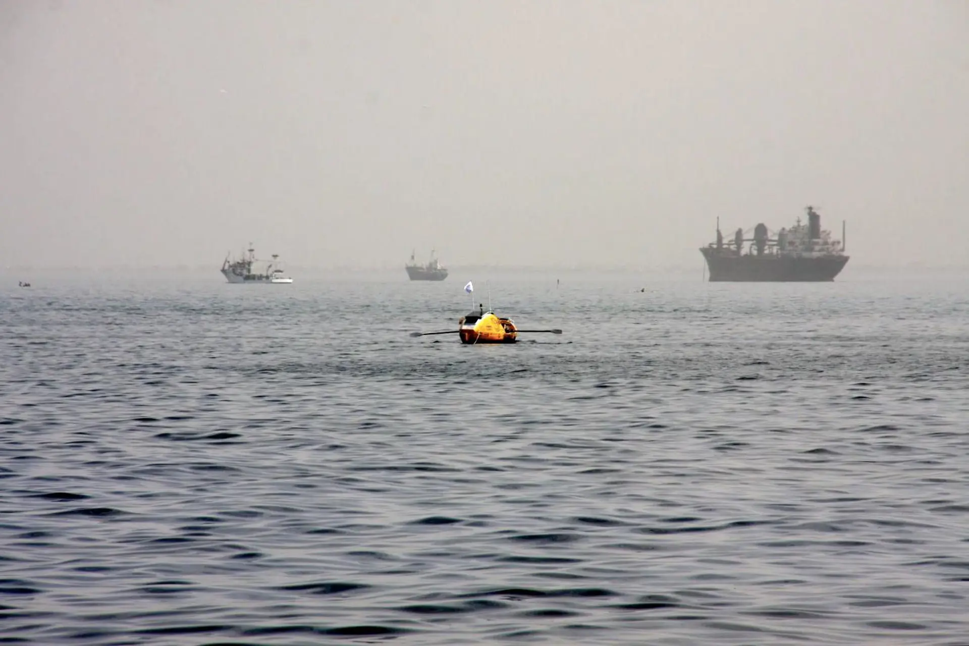 Person in a boat rowing ocean.