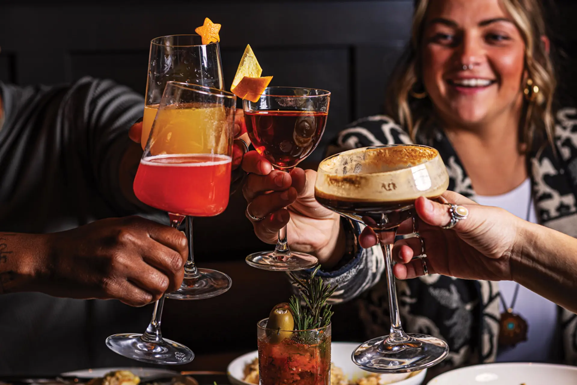 a group of drinks raised in cheers