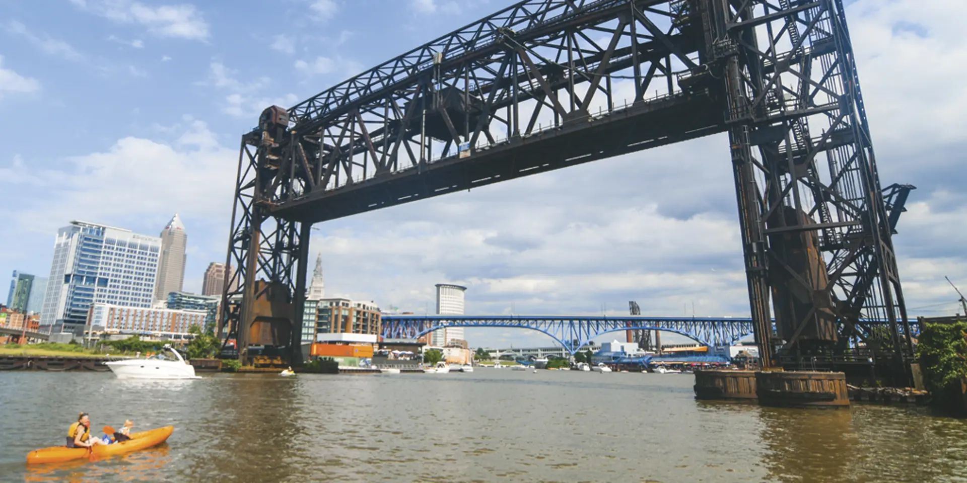 Kayakers, rowers and freighters all share the river in Cleveland’s Flats.