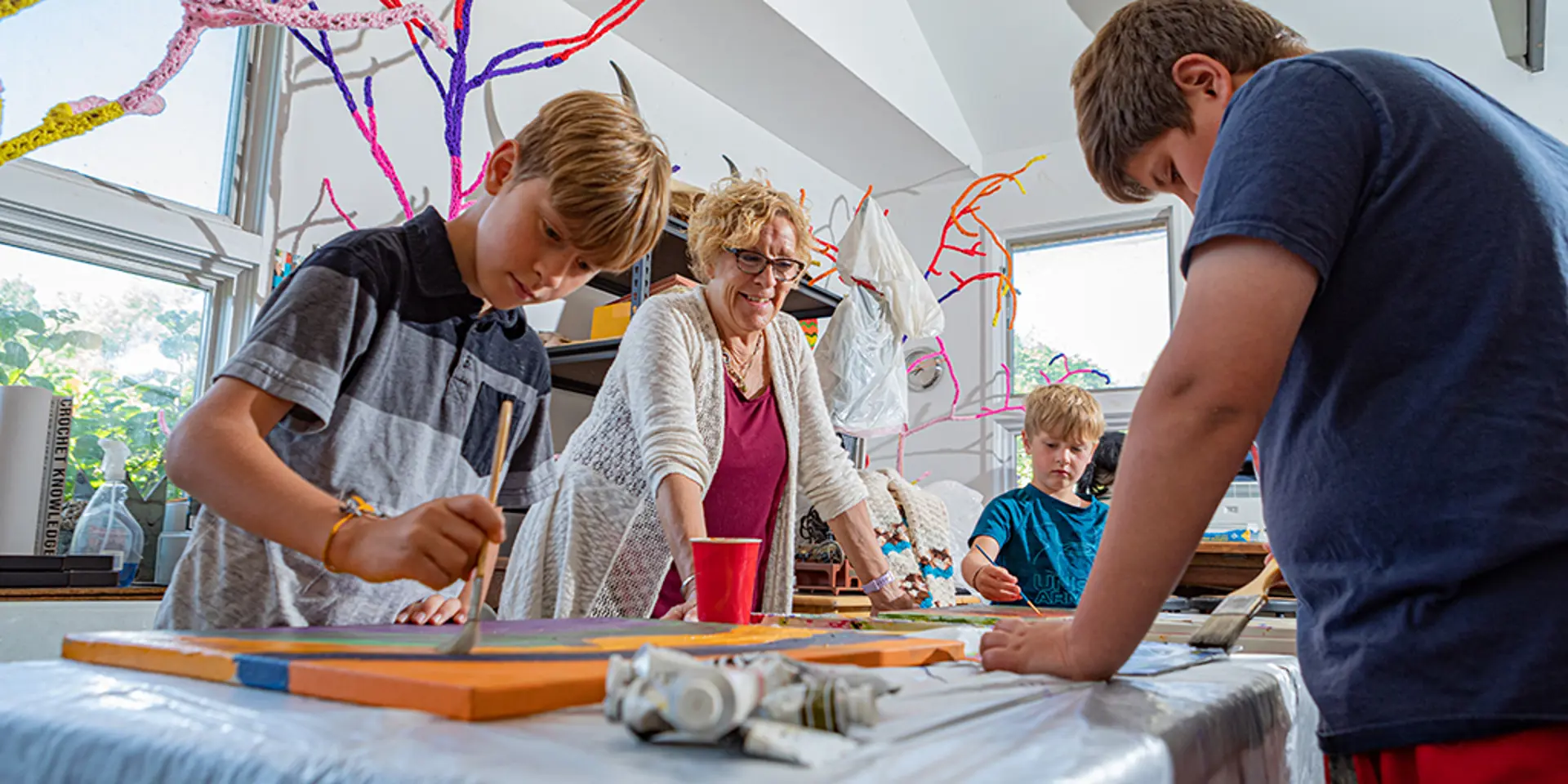 Carol Hummel leading an art class with children.