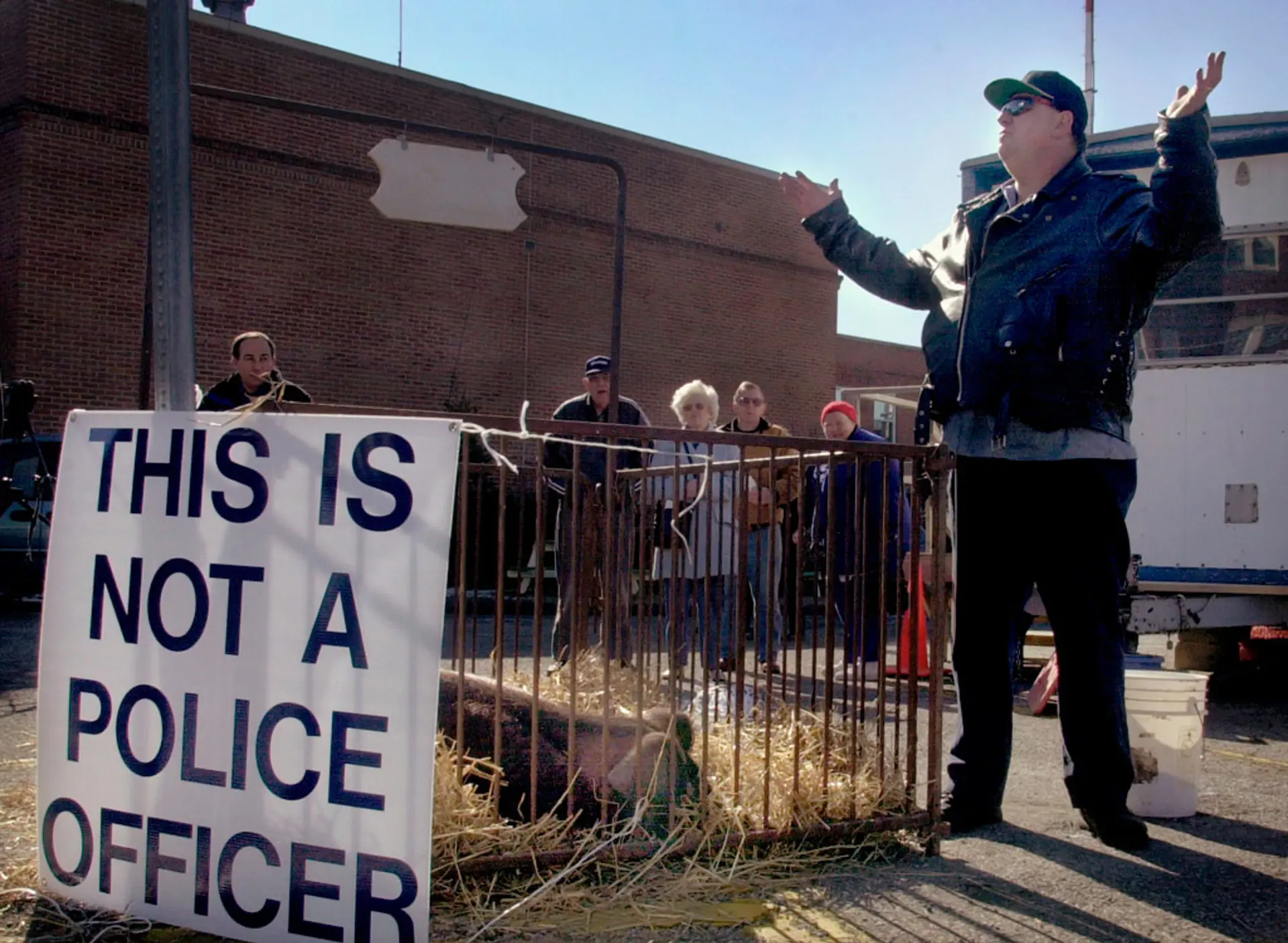 In 2002, Judge Michael Cicconetti sentenced a man who almost hit a police officer with a car and called the officer a "pig" to stand on the street next to a prize-winning sow with sign proclaiming, "This is not a police officer." | AP PHOTO/THE PLAIN DEALER, CHRIS STEPHENS