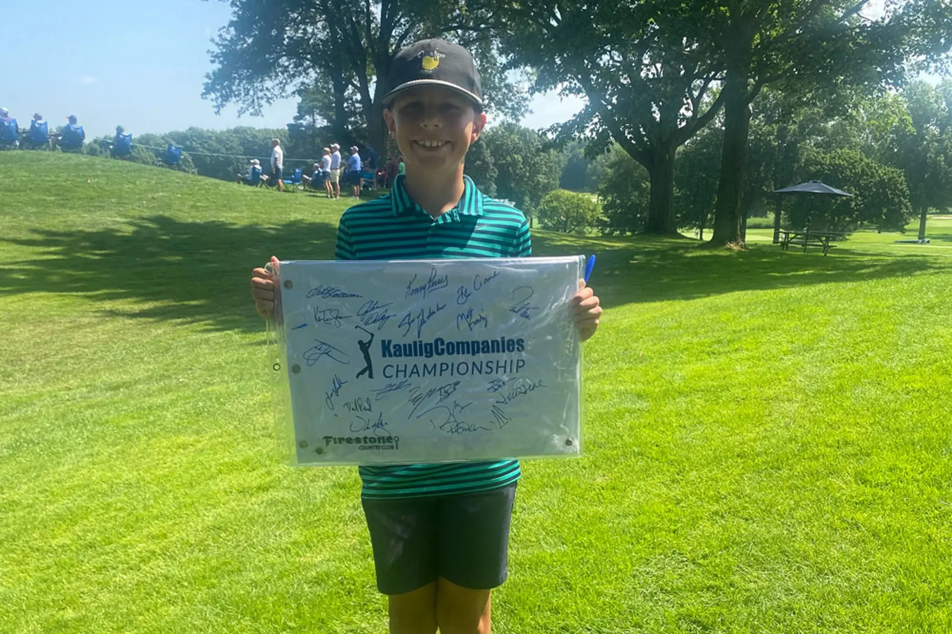 William Harrison, 12, of Avon, showing his autographed tee flag. | Photographed by Vince Guerrieri