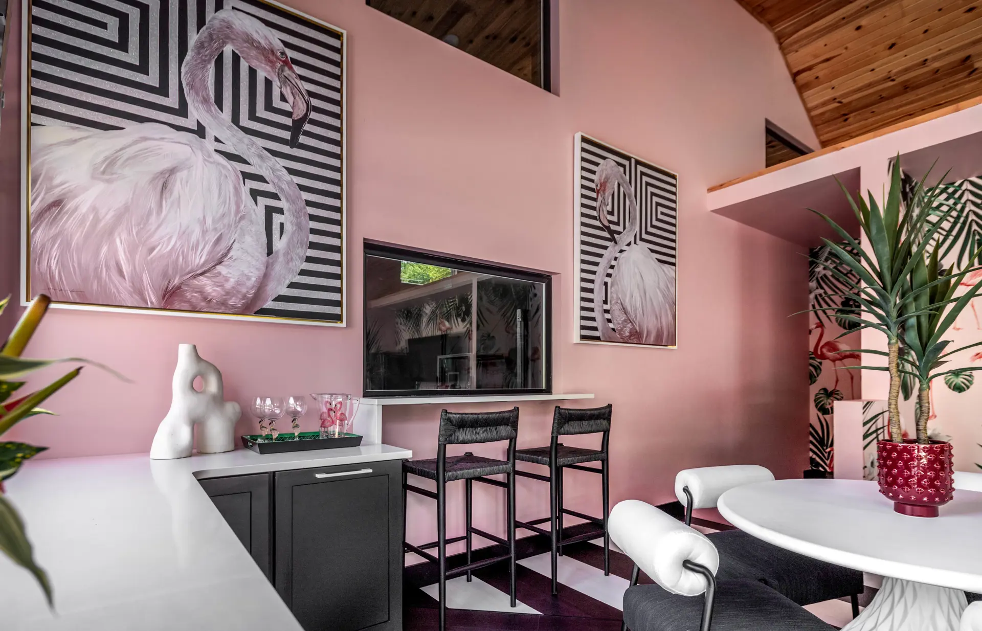 pink pool house with flamingo wall art