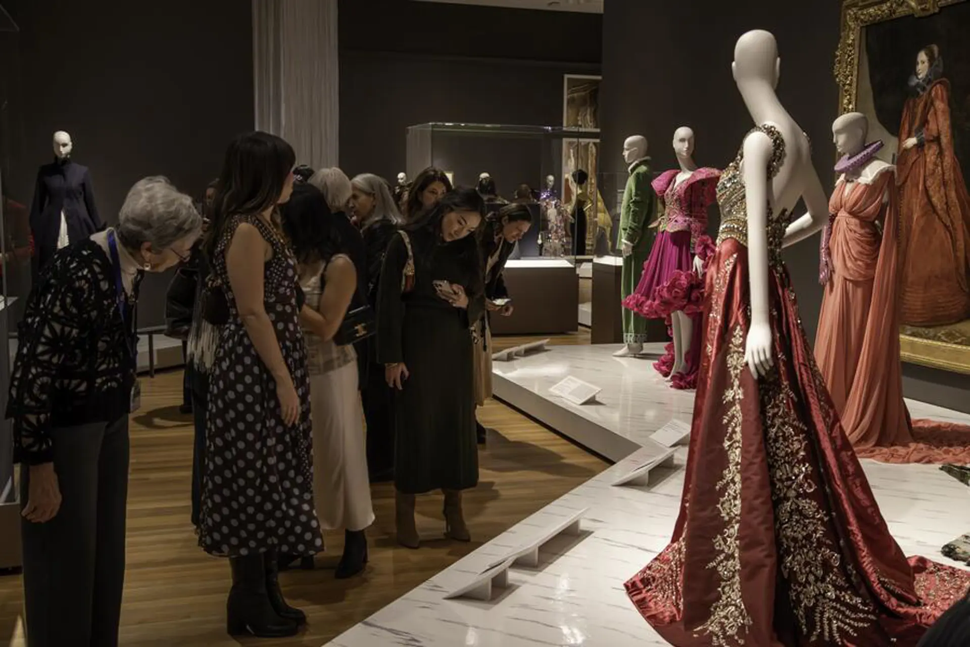 People attending a fashion exhibition at the Cleveland Museum of Art.