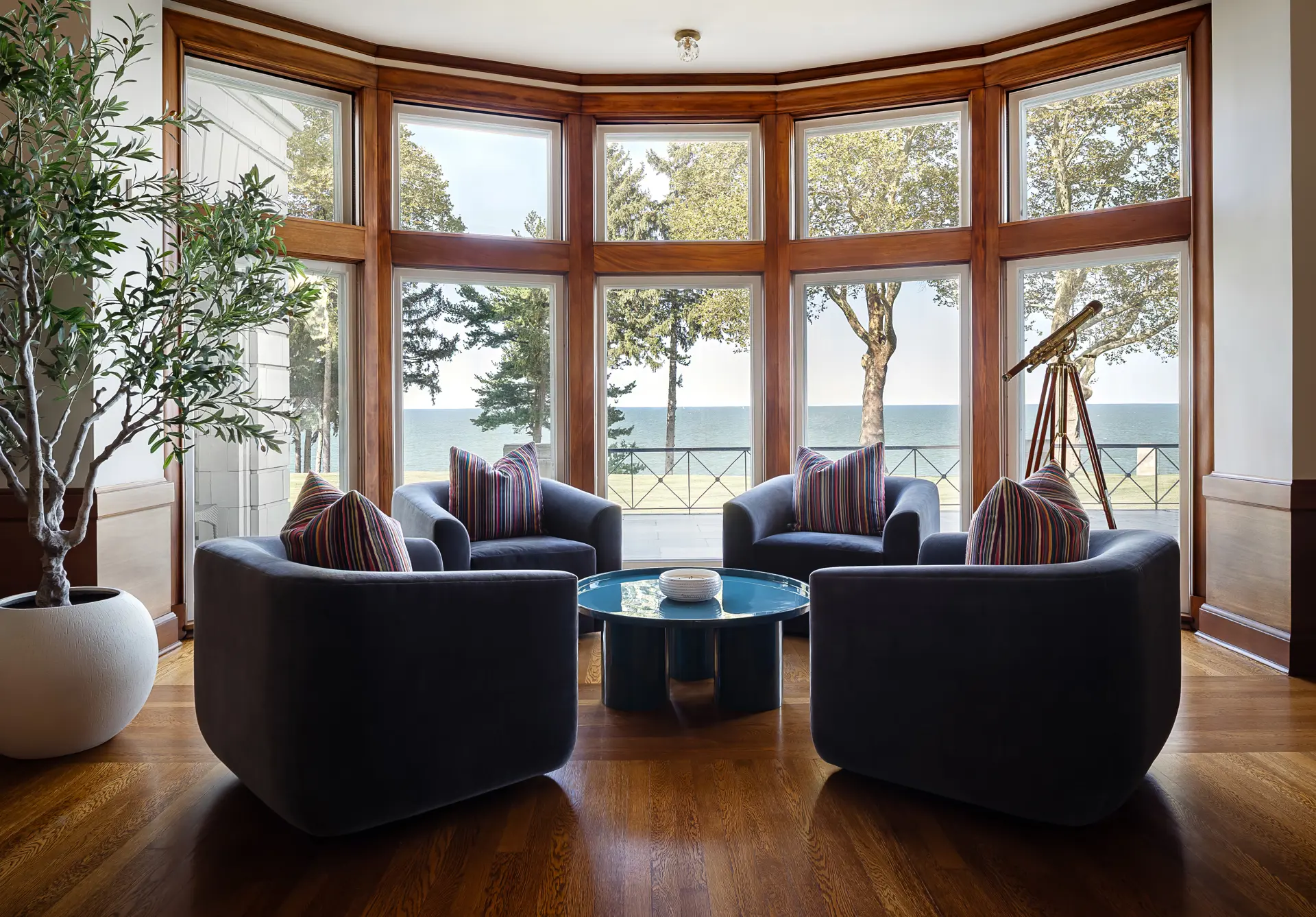 wall of windows behind blue swivel chairs