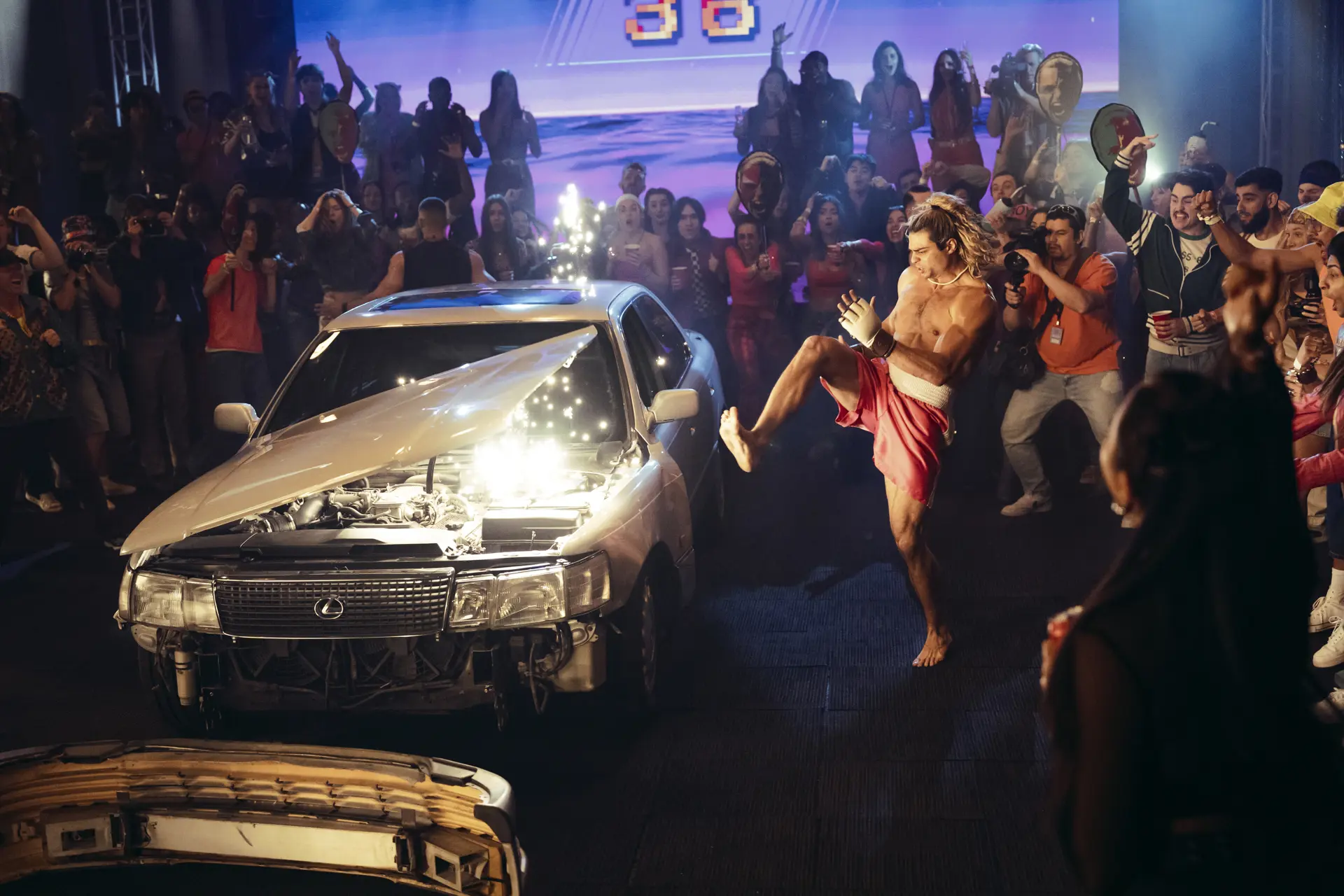 Scene from "Street Fighter" movie 2026 with a car and people fighting around it.