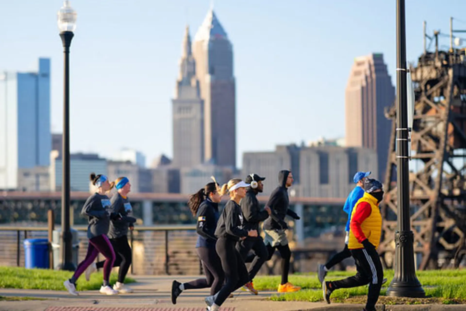 Runners pass the Cleveland skyline. By Erik Drost
