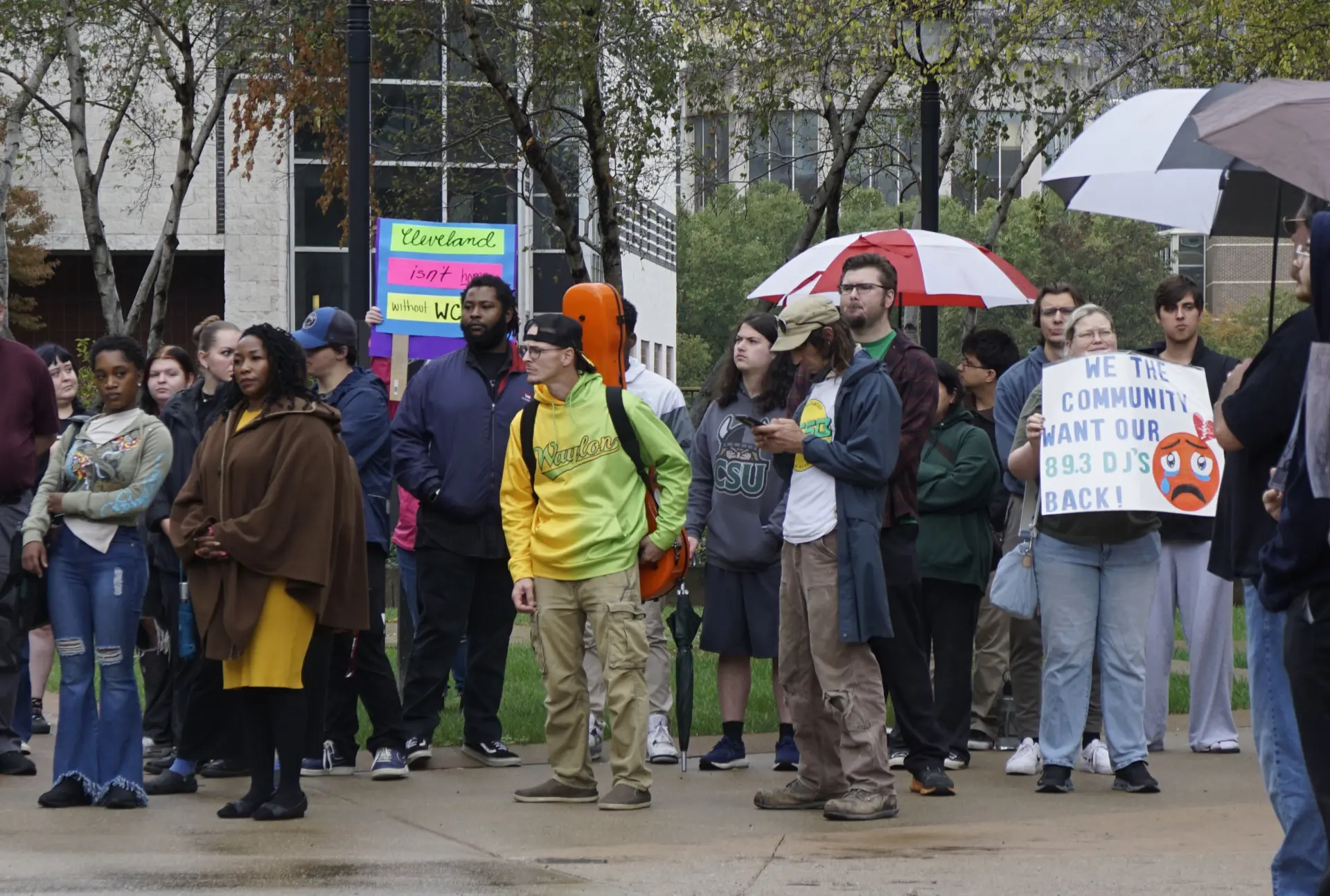 Protesters gathered with umbrellas and signs in support of WCSB.