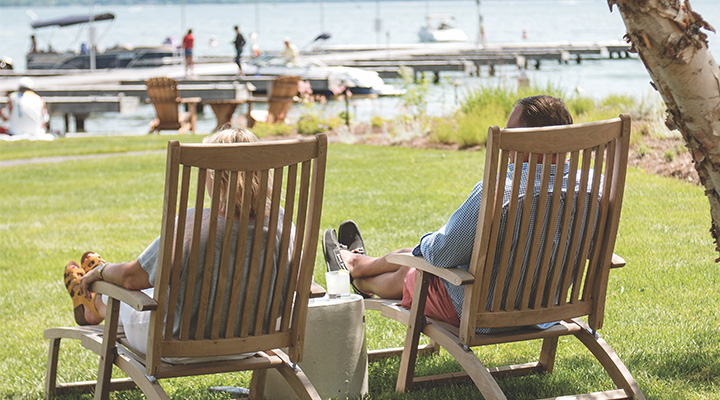 Couple sitting in lawn chairs lakeside at The Lake House on Canandaigua in Canandaigua, New York (photo courtesy of The Lake House on Canandaigua) Couple sitting in lawn chairs lakeside at The Lake House on Canandaigua in Canandaigua, New York (photo courtesy of The Lake House on Canandaigua)