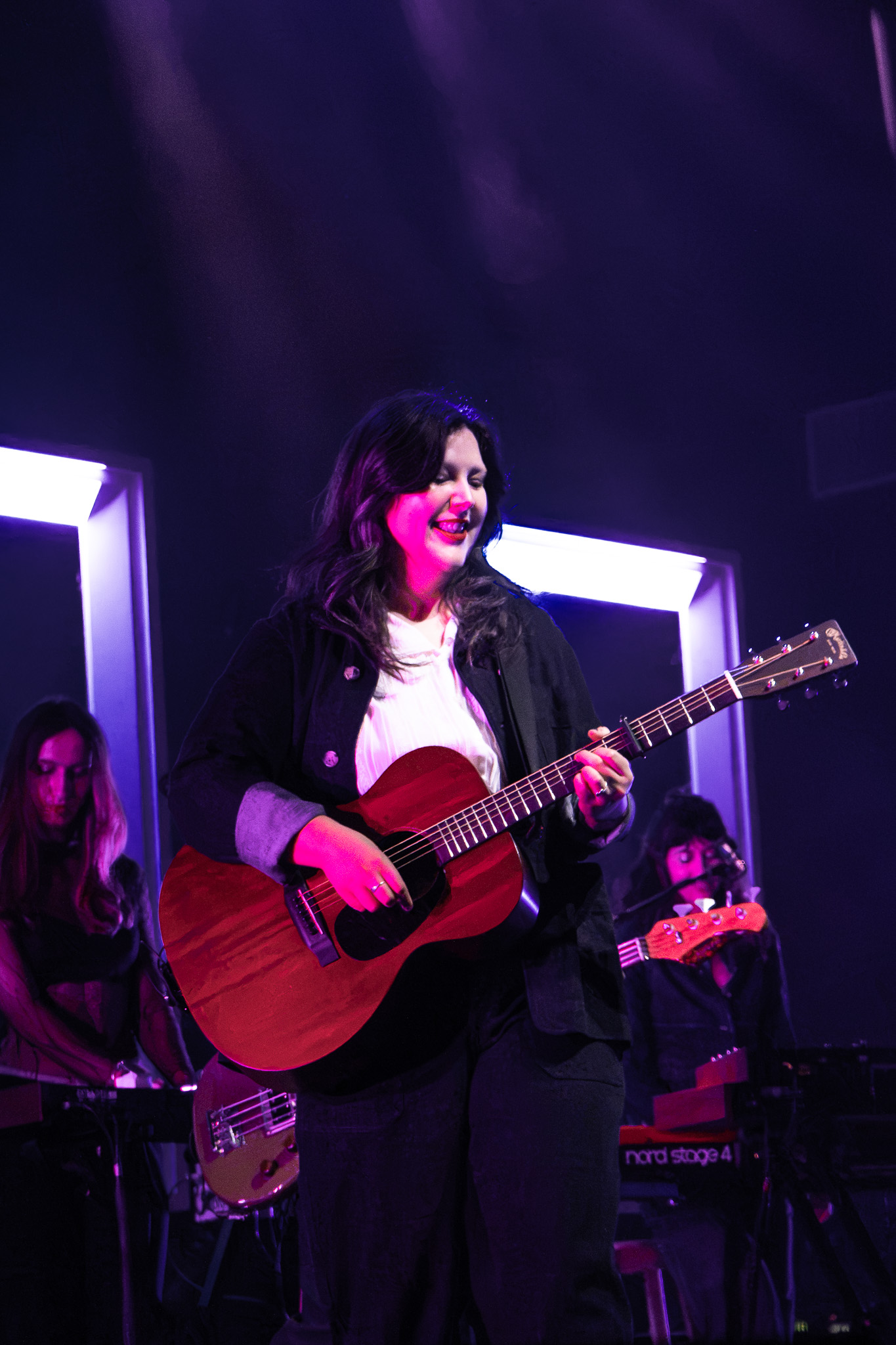 Lucy Dacus on stage with her guitar
