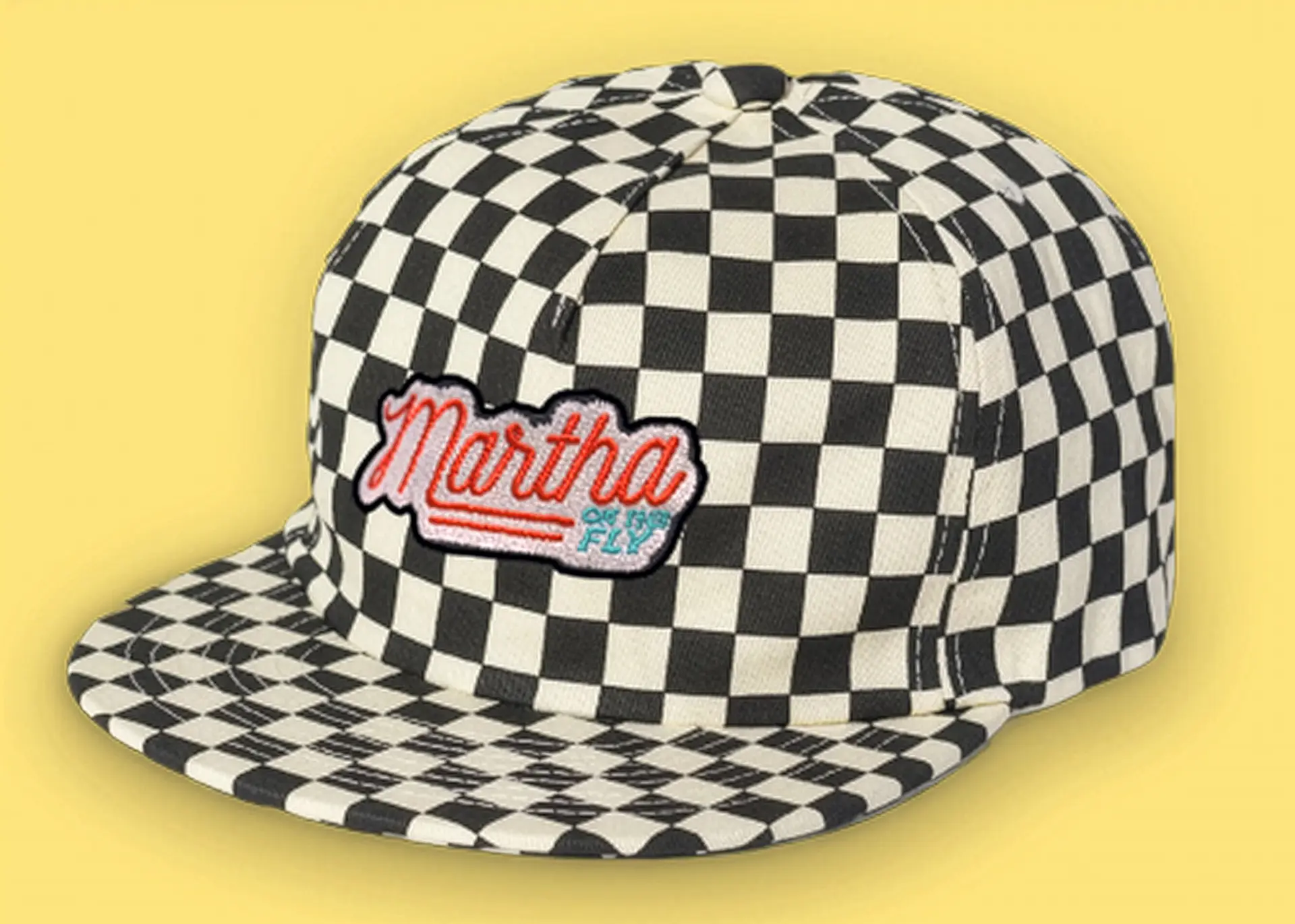checkered hat with Martha on the Fly logo