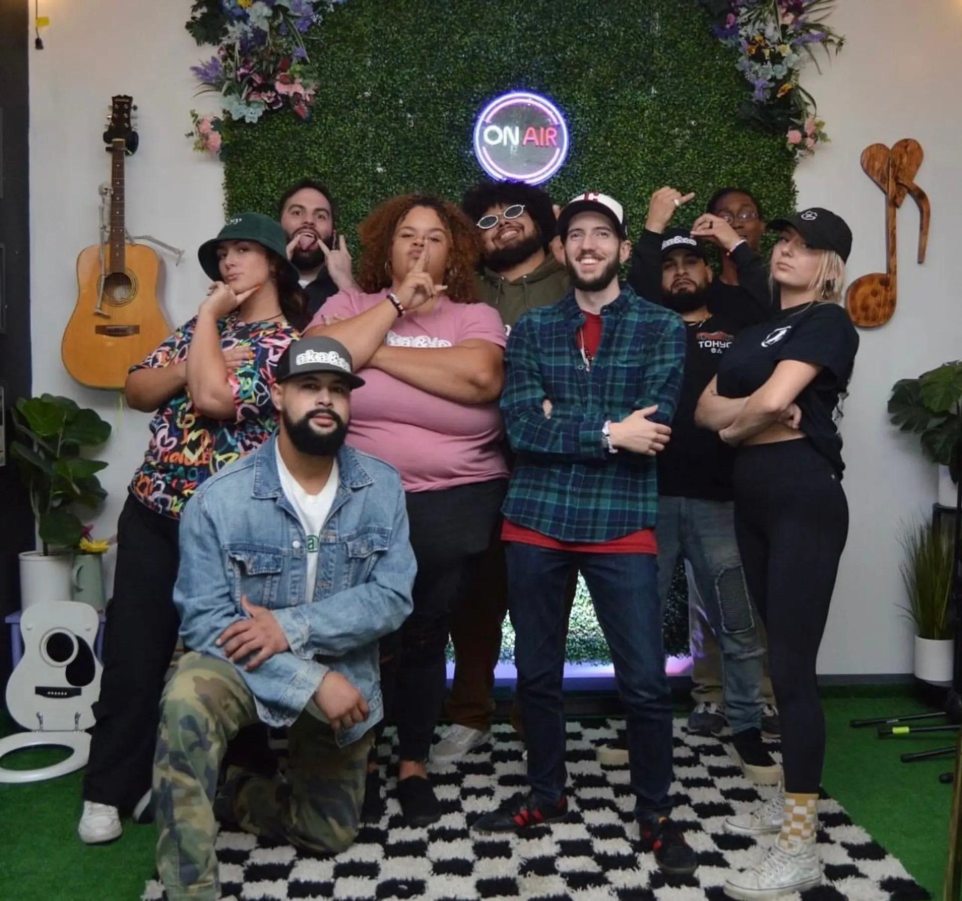 Photo of band posing with podcast hosts.