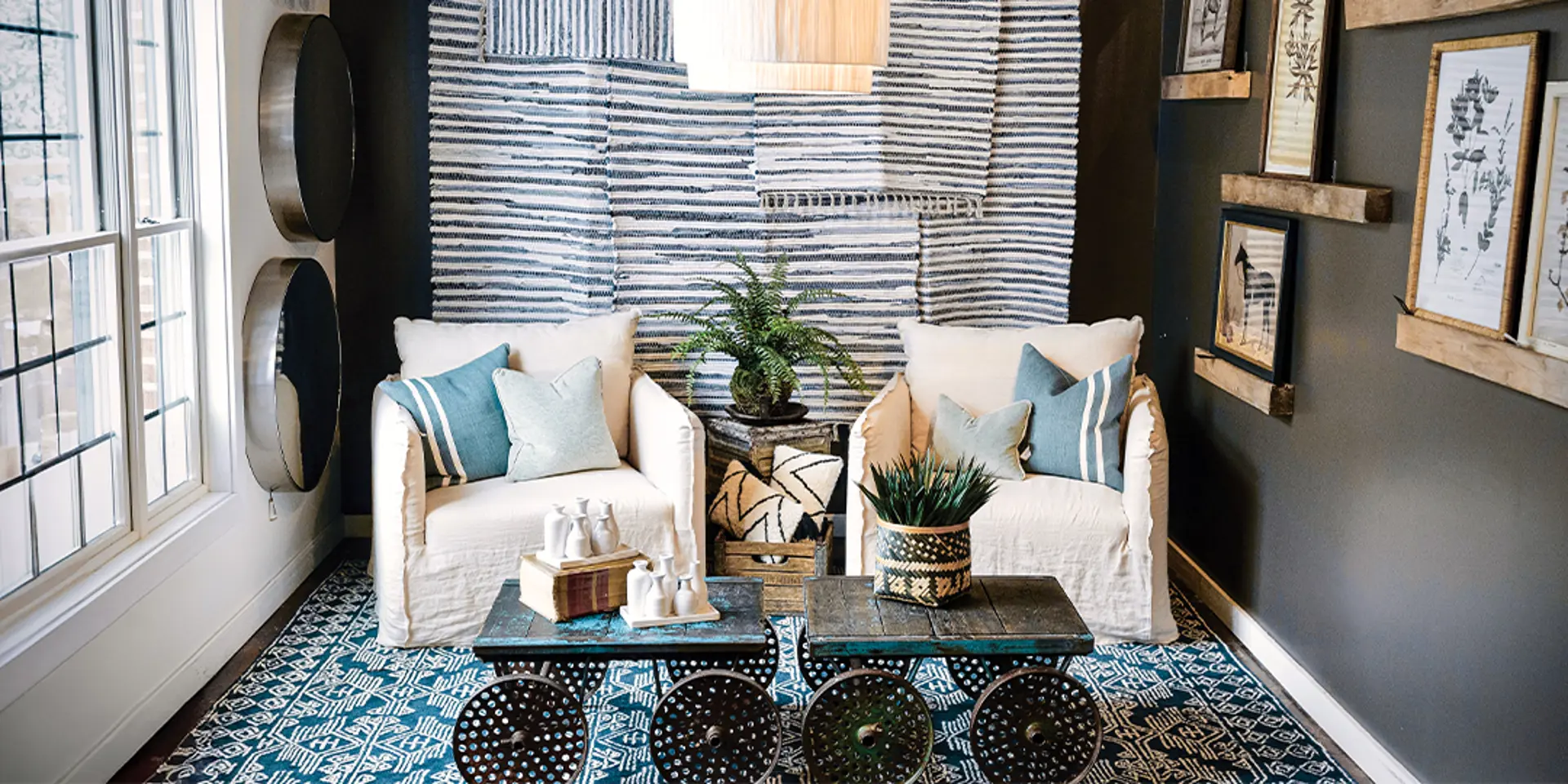 two cream chairs decorated with blue throw pillows