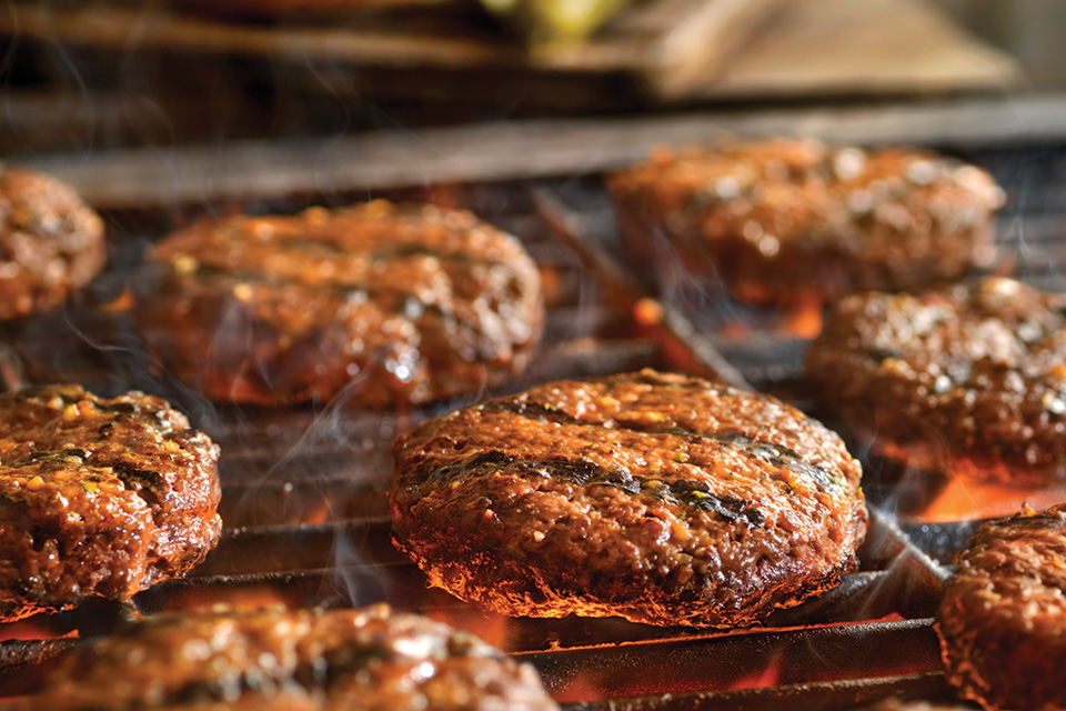 Hamburgers cooking on the grill (photo by Istock)