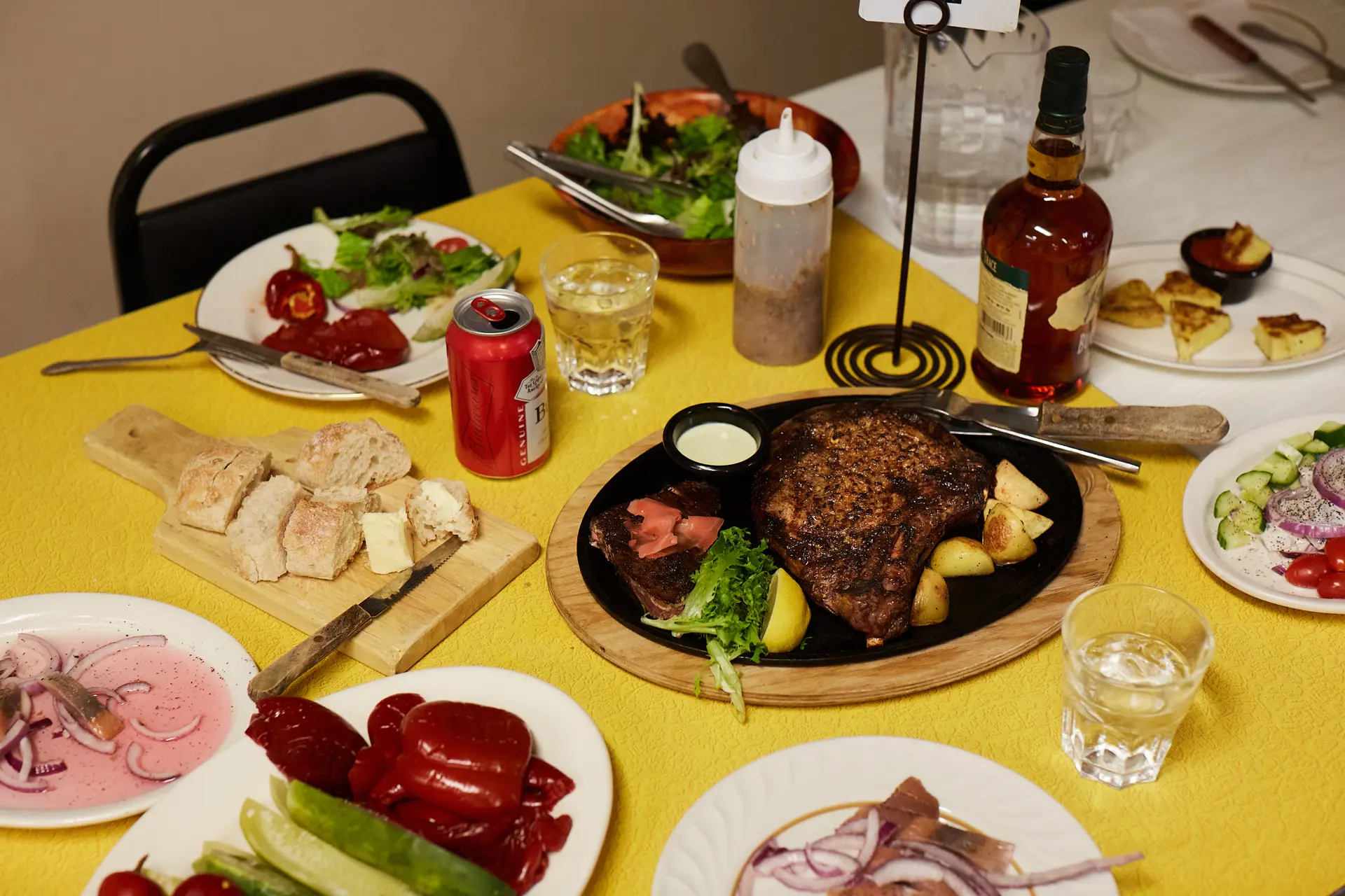 Platter of steaks, fries, sauce and more.