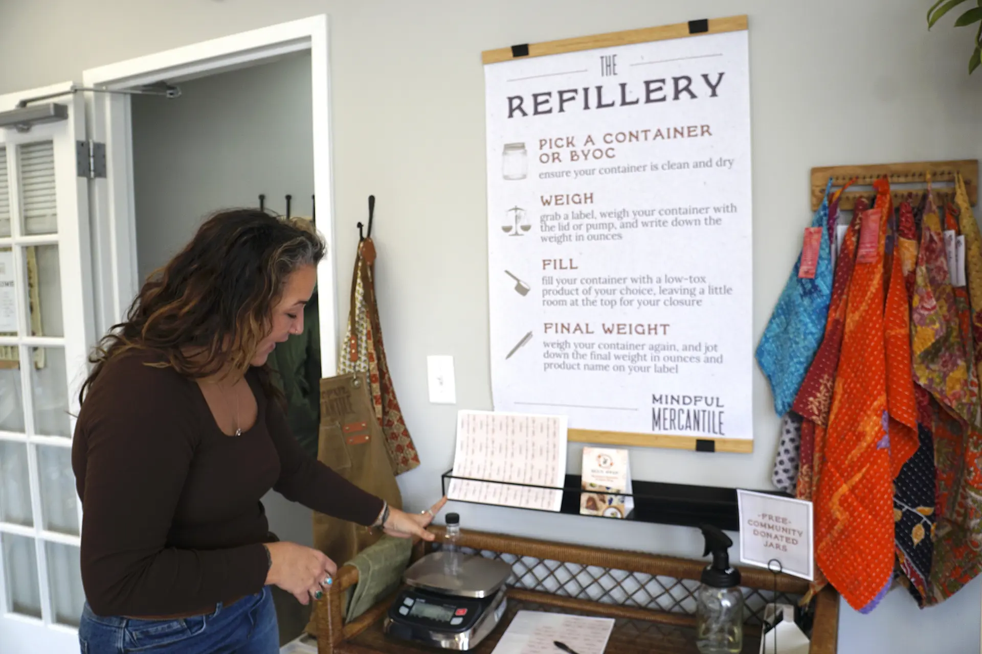 Rachel Kovach standing near instructions for refillery