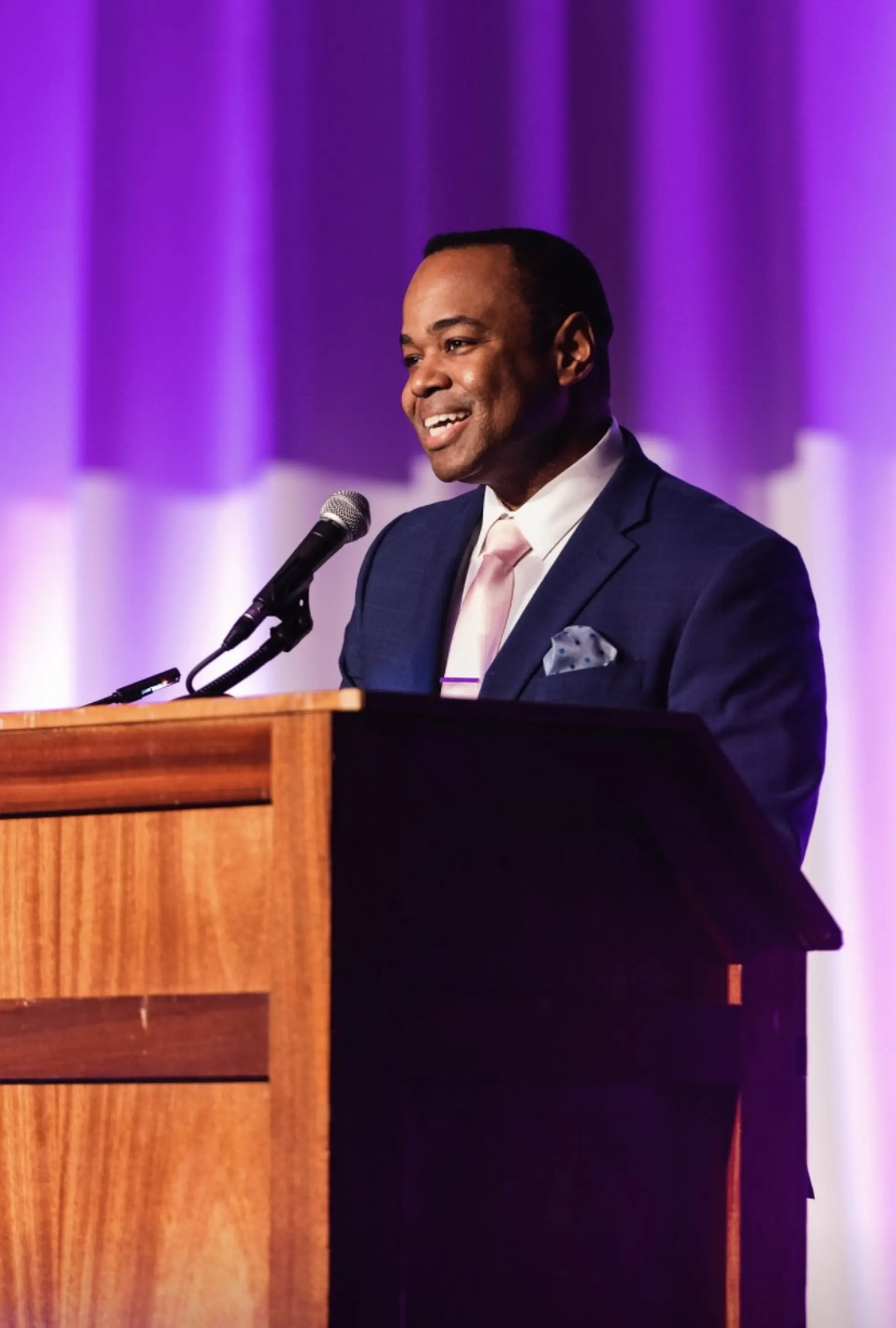 Michael Jeans speaking into a microphone