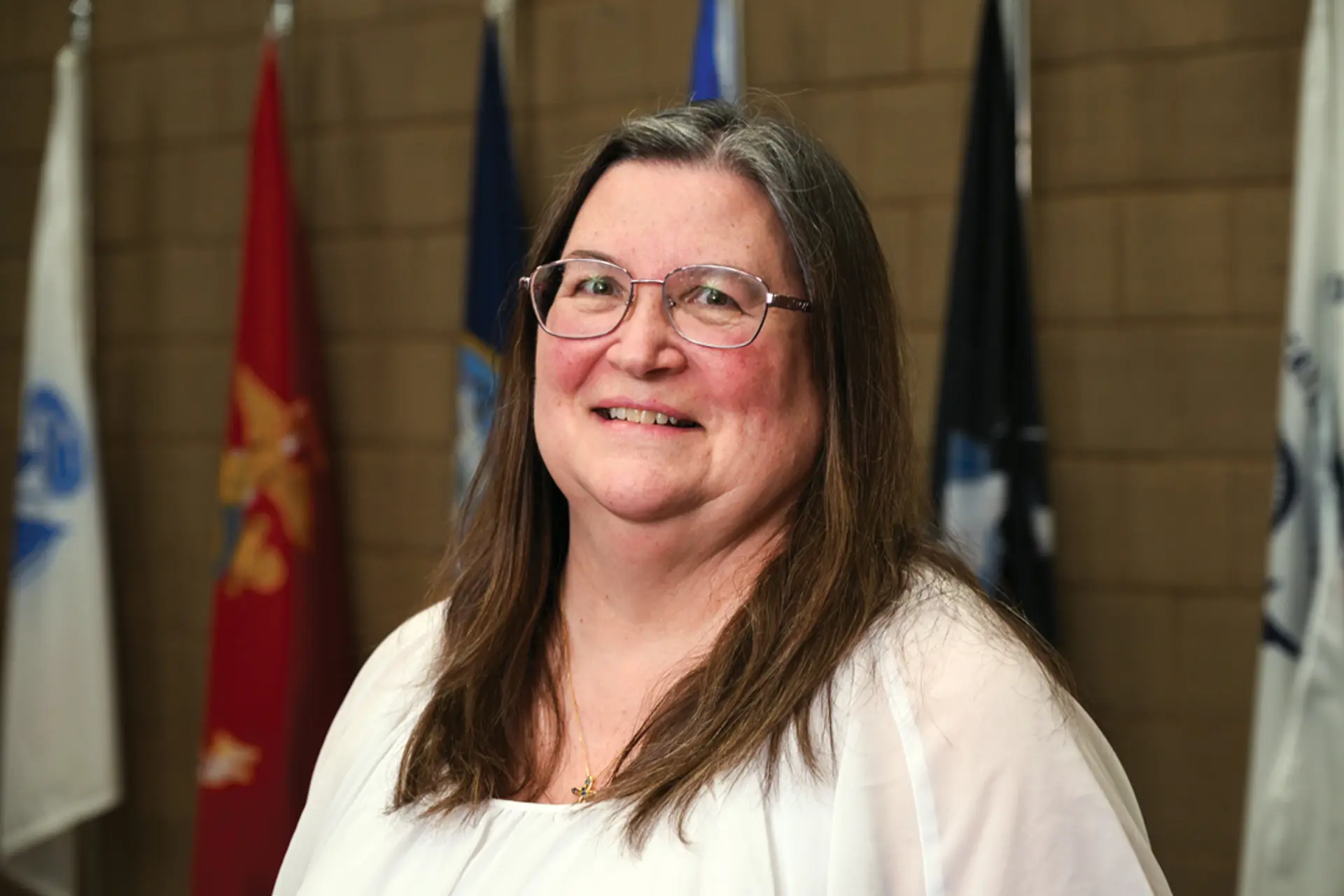 a woman in glasses smiling