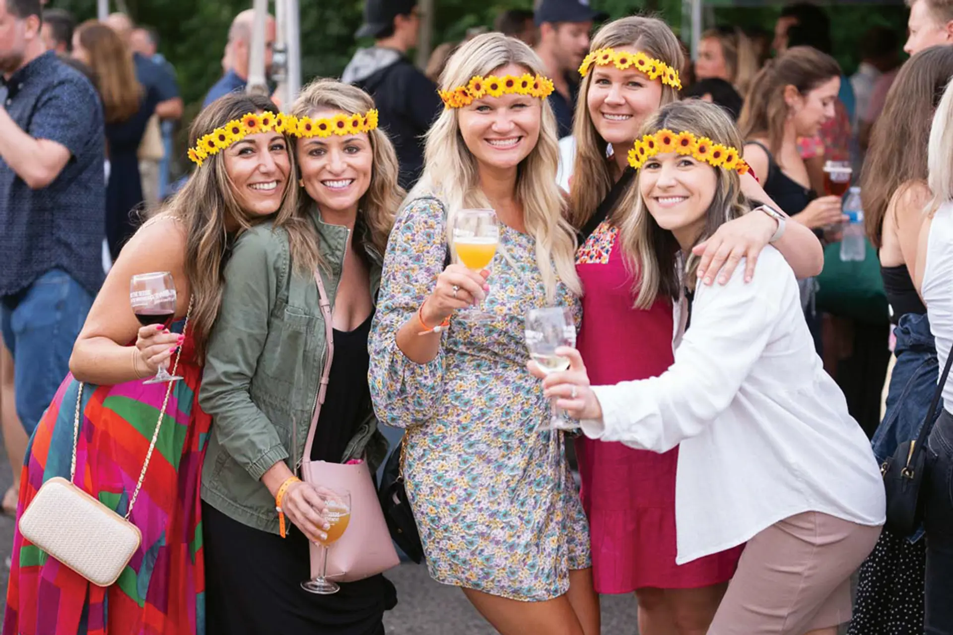 A group of women holding wine glasses and smiling