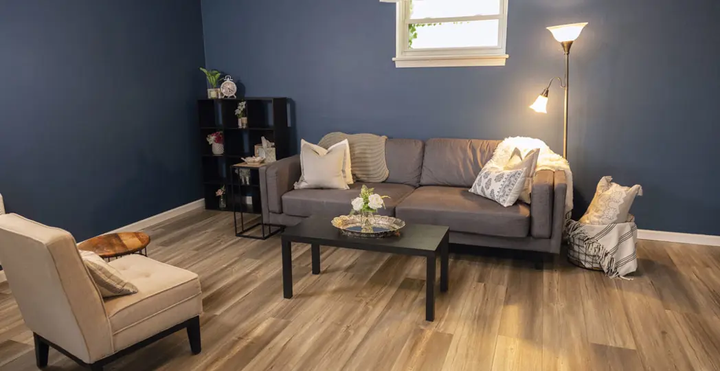 room set up with a couch and a chair