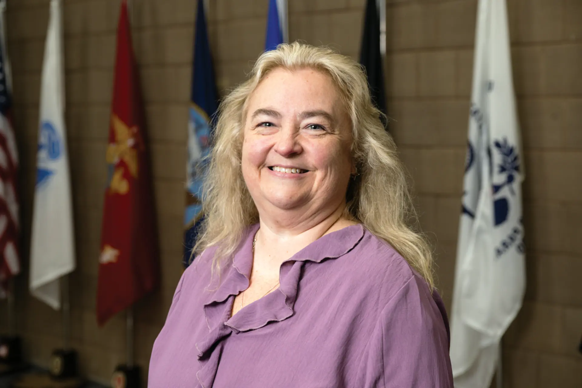 a woman in purple smiling