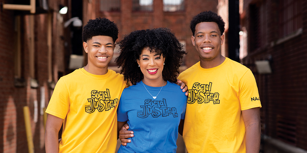 Three people smiling.