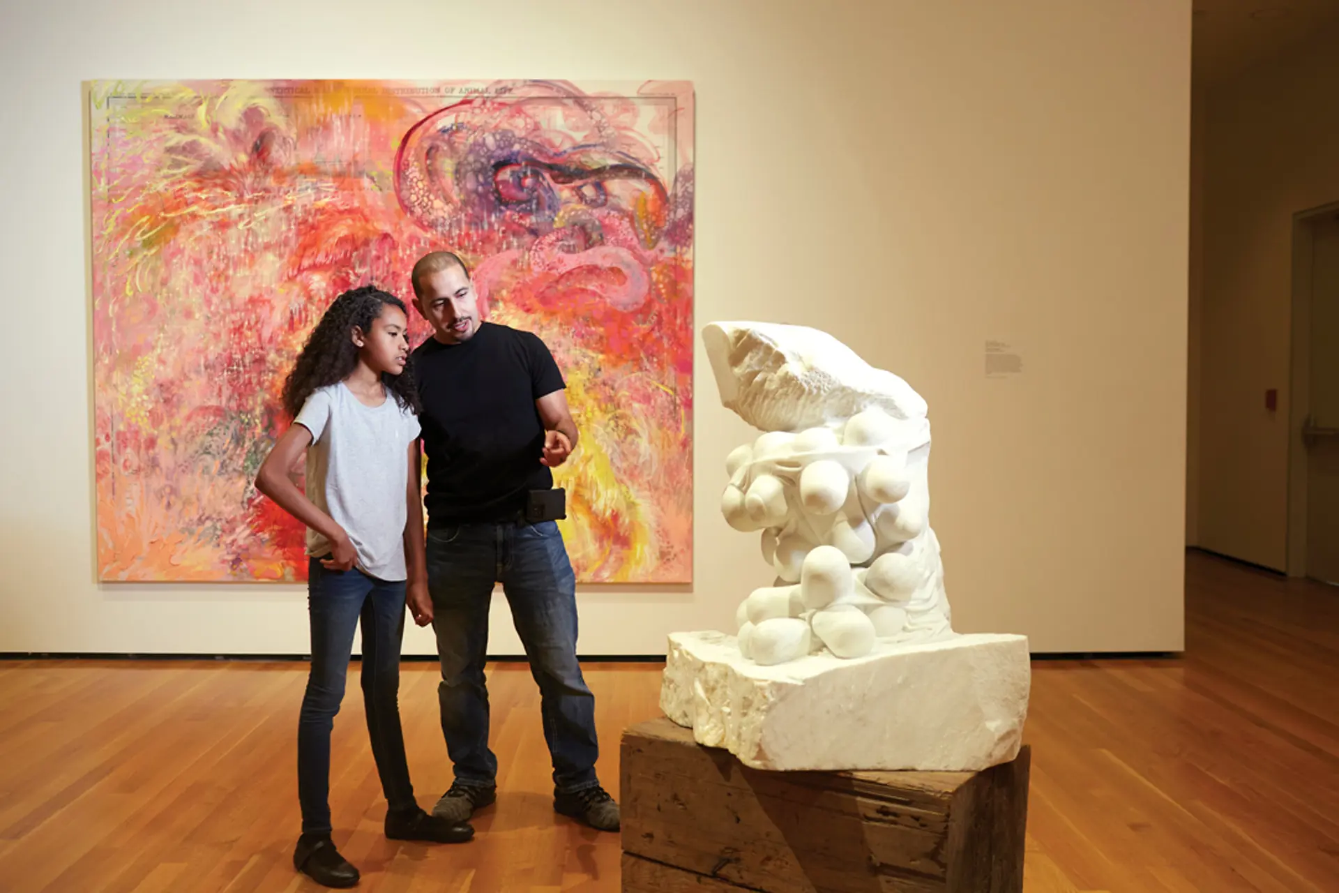 A couple people viewing a sculpture at the Cleveland Museum of Art