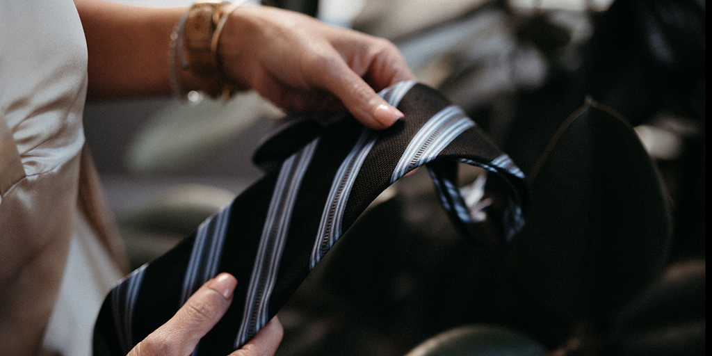 Hand holding a neck tie.