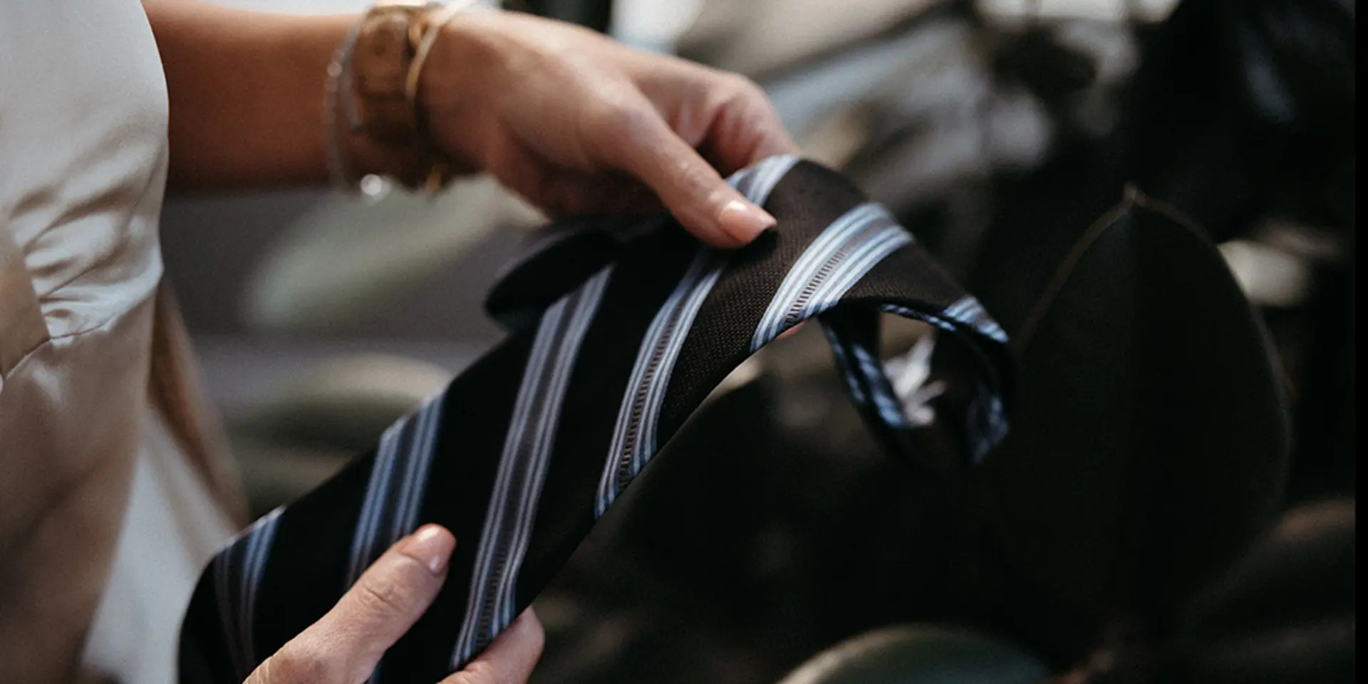 Hand holding a neck tie.