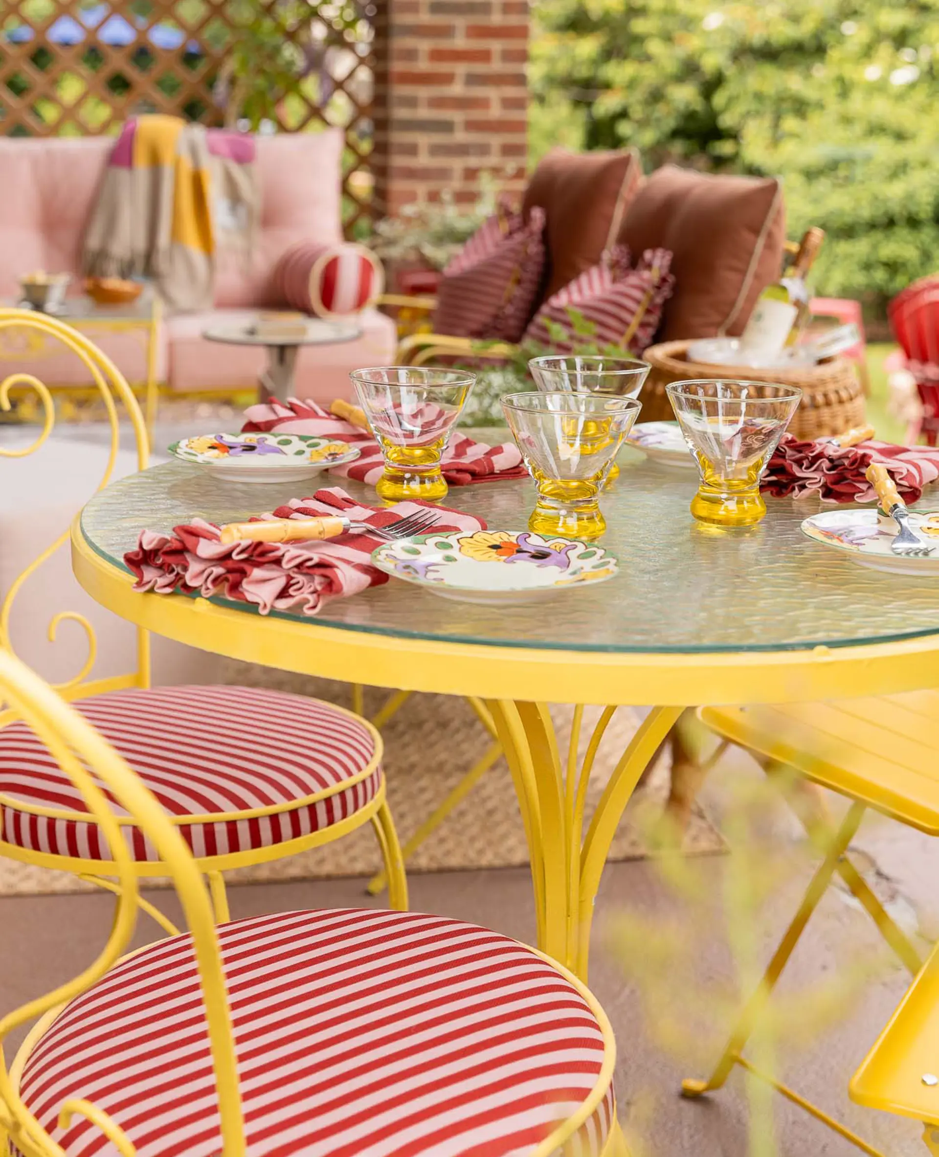 porch with yellow table and pink couch