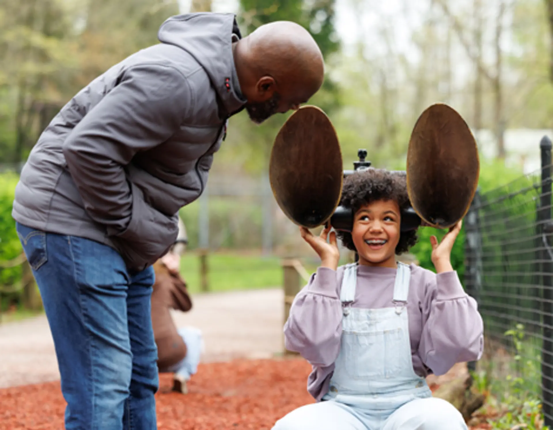 A daughter and dad interact at the Zoo