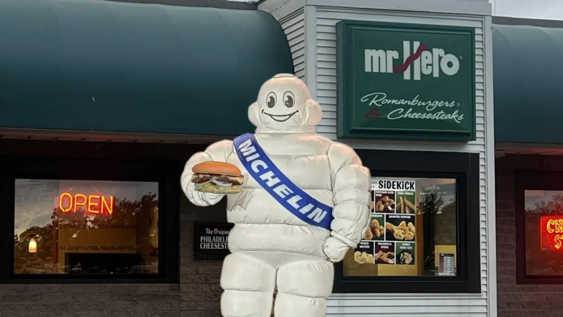 Michelin Man in front of a Mr. Hero restaurant