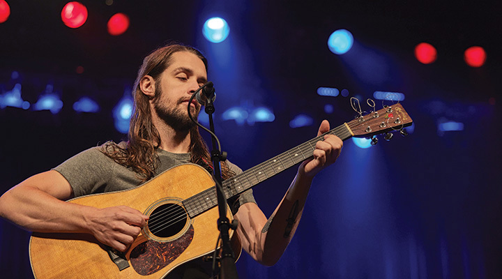 Man playing acoustic guitar at Mountain Arts Center in Prestonburg, Kentucky (photo courtesy of Kentucky Tourism)
